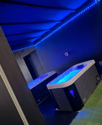 Hot tubs lit in blue at Reset Factory